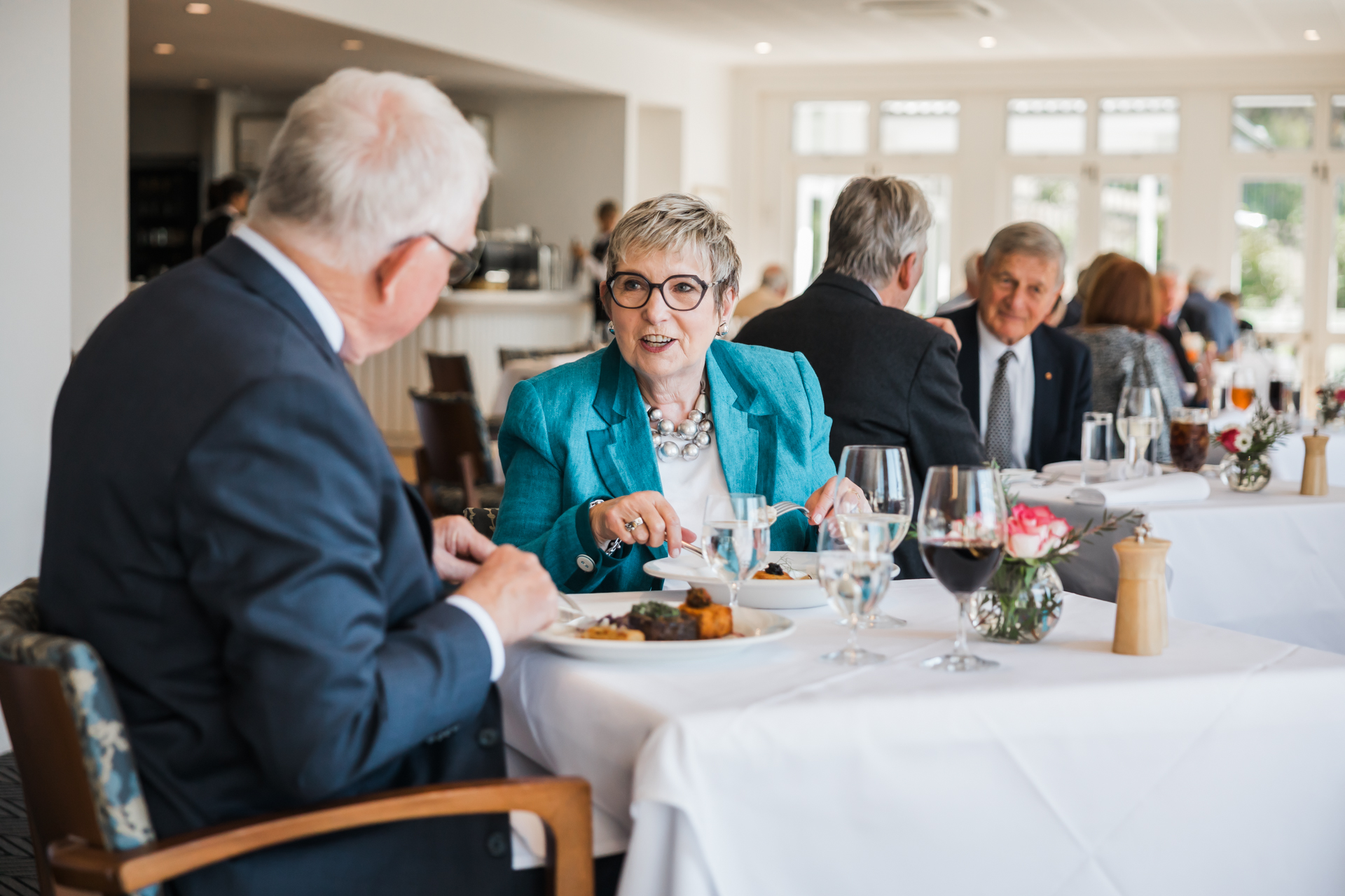 Members enjoying a meal in the Garden Room.